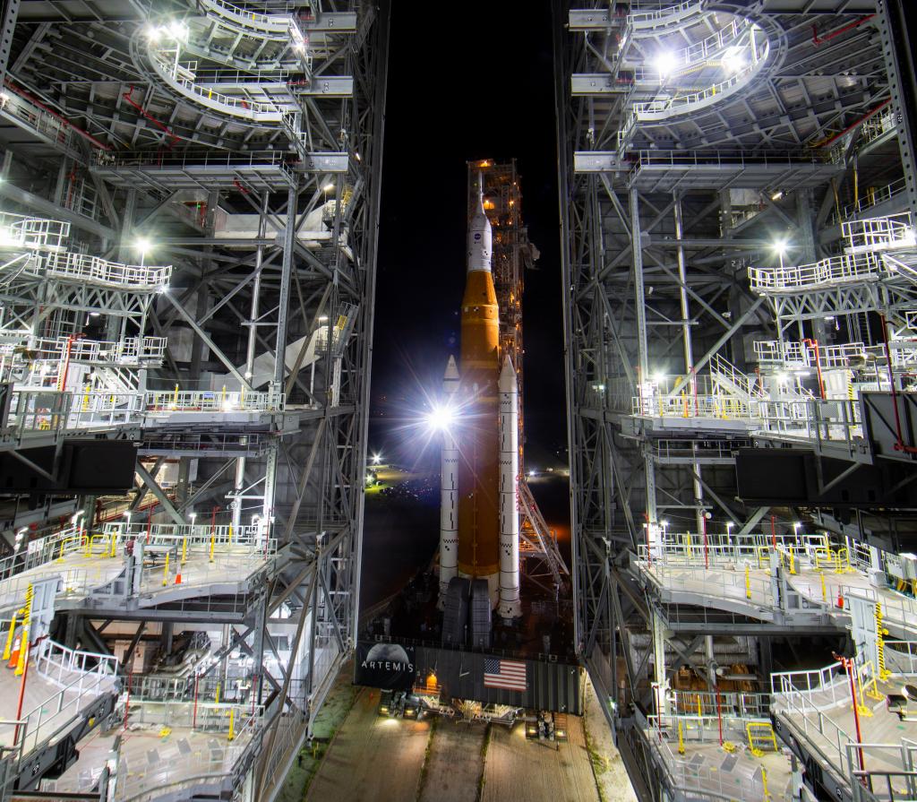 NASA’s Space Launch System (SLS) rocket with the Orion spacecraft aboard is seen at night atop a mobile launcher as it rolls out of the Vehicle Assembly Building to Launch Pad 39B