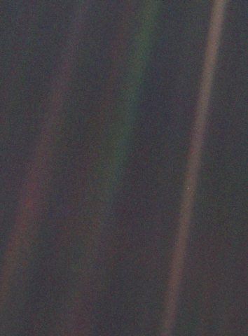 image of Earth from over 6 billion kilometres away. Earth looks like a pale blue dot suspended in sunbeam