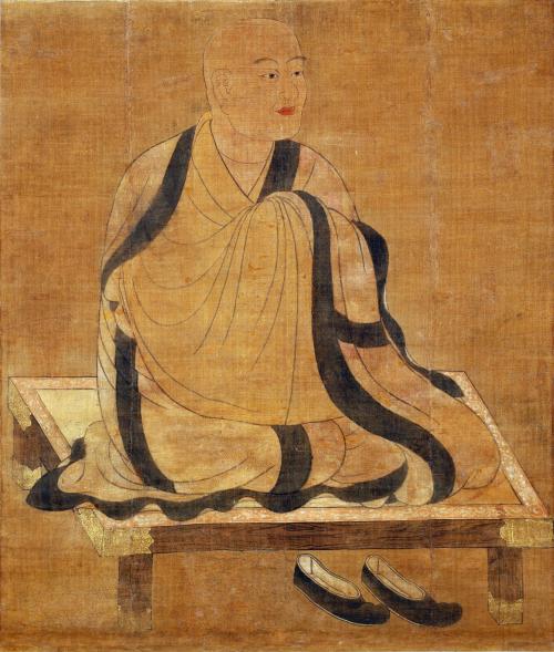 A painted illustration of a bald man sitting on a low wooden surface. He seems to have his legs crossed and his hands joined, but the flowing robe he wears covers these from view.