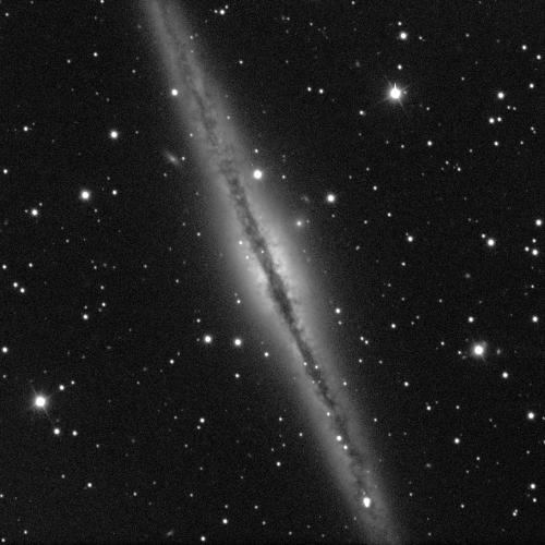A thick, grey, fuzzy line stretches across the image from the upper left to the lower right. Within this, there is a brighter, white, circle in the middle, and a bumpy, dark, thinner line stretches the whole length too. The background is black with white dots of stars.