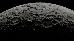 A close-up view of the Moon's surface. The bottom of the image is in shadow.